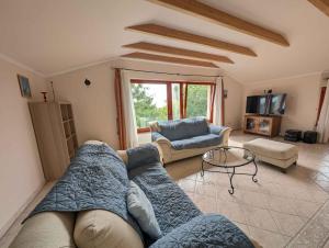 a living room with a couch and a table at Holiday home Balatonalmadi - Balaton 17957 in Balatonalmádi