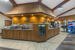 a large kitchen with wooden walls and a counter at Best Western Maritime Inn in Sturgeon Bay