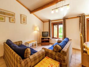 a living room with two couches and a tv at Holiday Home in Bredene near Sea and Lake in Bredene