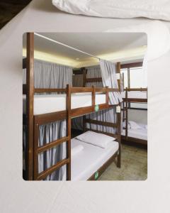 a group of four bunk beds in a room at Teofel Hostel by Hiverooms in Sampong
