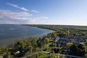 an aerial view of a river with houses and trees at Tranquil Lakeside Townhouse in Severn