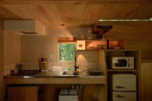 a kitchen with a sink and a microwave at ist - Aokinodaira Field in Kawakami