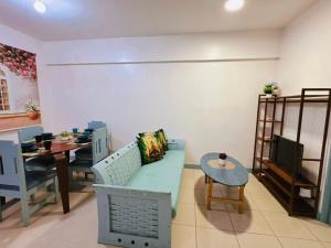 a living room with a couch and a table at Stan Condo in Manila
