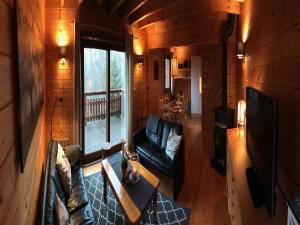 a living room with a couch and a table at Holiday Home in Auvergne near Lake in Beaulieu