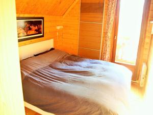 a bed in a room with a tv on the wall at Holiday Home in Auvergne near Lake in Beaulieu +32 photos