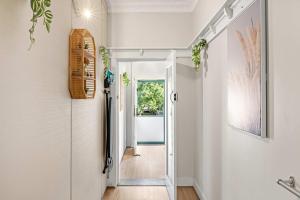 a hallway with white walls and a white door at Boutique Double Room Near Light Rail in North Parramatta - Shared Bathroom in Sydney