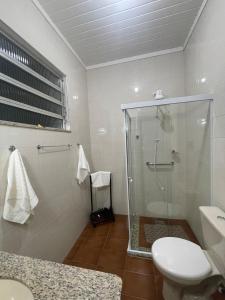 a bathroom with a glass shower and a toilet at Casarão Cidade Imperial in Petrópolis +59 photos