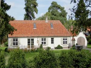 a white house with an orange roof at Holiday home with 3 bedrooms in Koksijde