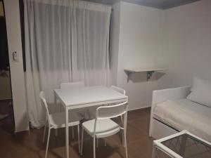 a small room with a table and chairs and a bed at Spacious Condo with 2 queen beds in Sosua walking distance from everything in Sosúa