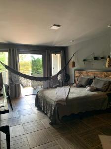 a bedroom with a bed and a large window at Hotel Sinhá in Tianguá +24 photos