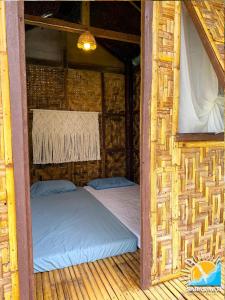 a bed in a room in a straw hut at Saraswati Exclusive Resort in Esperanza +29 photos