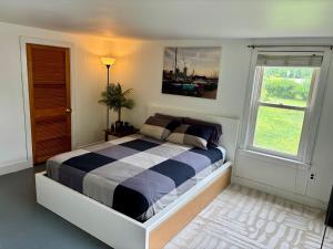 a bedroom with a bed and a window at 2-Bedroom Retreat in Charming Small Town in Derry