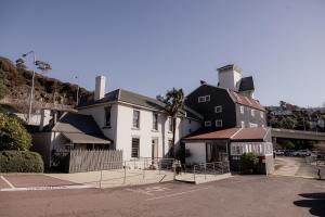 a white house with a black and white building at Light and Bright Trevallyn Stay with River Views in Royal Park