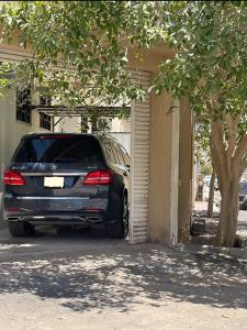 a car parked in a garage next to a building at شقة الخالدية 1 in Al Madinah
