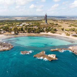 an island with a lighthouse in the middle of the ocean at Casita Linda in Arecibo