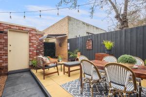 a patio with a wooden table and chairs at Gloria of Healesville in Healesville