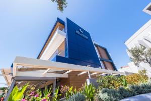 a building with a blue sign on it at Island Boutique Hotel in Rhodes Town