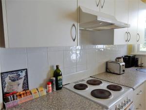 a kitchen with a stove with cookies on it at Donlan's Delight - steps from Mollymook sands in Mollymook