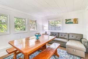 a living room with a table and a couch at Walk to Crystal River Home with Lanai and Yard! in Crystal River