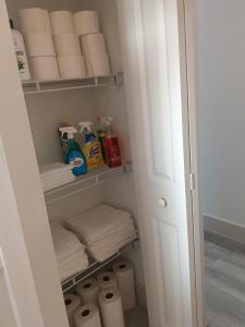 a closet filled with lots of toilet paper and towels at THE WHOLE HOUSE, QUIET COZY HOME 4 Bed 3 bath in Ocala +14 photos