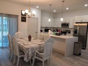 a kitchen and dining room with a table and chairs at THE WHOLE HOUSE, QUIET COZY HOME 4 Bed 3 bath in Ocala