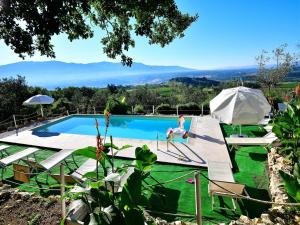 a villa with a swimming pool with mountains in the background at Apartment with pool, Rignano in San Cristoforo a Perticaia