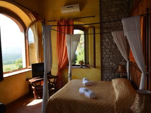a bedroom with a canopy bed with a window at Apartment with pool, Rignano in San Cristoforo a Perticaia