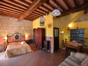 a bedroom with a bed and a table and a couch at Apartment with pool, Rignano in San Cristoforo a Perticaia