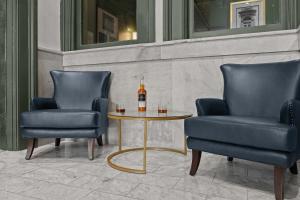 two chairs and a table with a bottle of wine at Bright and Modern Studio in Louisville # 301 in Louisville