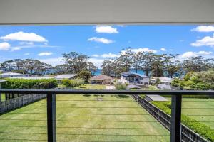 a view from the balcony of a house at Days By The Bay - 3BR house with ocean views in Hyams Beach