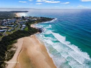 an aerial view of a beach with houses and the ocean at Sticks by the Sea - pet-friendly coastal home in Manyana