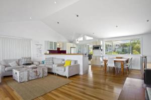 a living room with a couch and a table at Sticks by the Sea - pet-friendly coastal home in Manyana