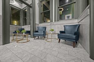 two blue chairs and tables on a patio at Bright and Modern Studio in Louisville # 303 in Louisville