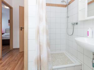 a bathroom with a shower and a sink at Ruhiger Bungalow am Hennesee mit Terrasse  +19 photos