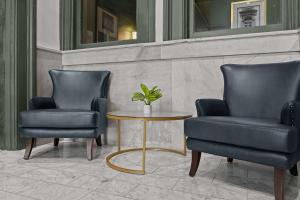 two chairs and a table with a plant on it at Bright and Modern Studio in Louisville # 304 in Louisville