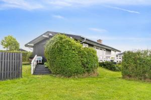 a house with a staircase leading to a yard at Lovely Summerhouse By Skaastrup Strand W Sea View in Bogense