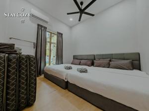a bedroom with a large bed in a room at Private Pool KTV Family Villa 3R 12Pax by I Housing in Kampong Solok Haji Dollah +38 photos