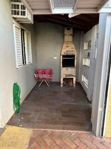 a patio with a fireplace in the back of a house at Casa inteira - ótima localização in Três Lagoas