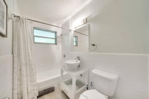 a white bathroom with a toilet and a sink at Beach Apart By Pmi Unit 2 in West Palm Beach +36 photos