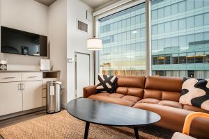 a living room with a couch and a table at Boulevard Stays Comfortable Downtown Highrise STU Pool Parking & Gym 10a in Phoenix