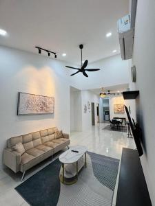 a living room with a couch and a ceiling fan at Villa Ammara Homestay in Ipoh