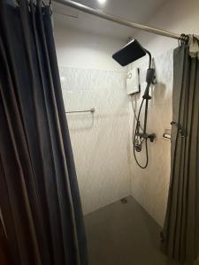 a shower in a bathroom with a shower curtain at DANK Hotel 420 friendly in Patong Beach