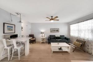 a living room with a couch and a table at Beach Apart By Pmi Unit 1 in West Palm Beach
