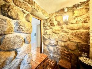 a room with a stone wall with a mirror at Farmhouse Apartment with Pool in Galapagar +32 photos