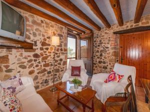 a living room with two chairs and a tv at Holiday Home in Cassà with Private Pool in Cassà de la Selva