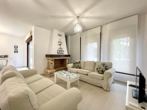a living room with two couches and a fireplace at Sunlit Villa near Golf in Motril