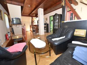 a living room with two leather chairs and a table at Holiday Home Bohemian near Ski Lift in Staré Křečany