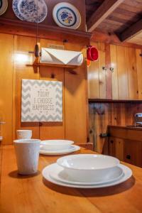 une table en bois avec trois plaques blanches dans l'établissement Idyllcottage Historic In-town, Hottub, Ac, Dog Ok, à Idyllwild