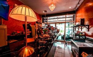 a restaurant with a bar with a row of wine glasses at DANK Hotel 420 friendly Patong Phuket in Patong Beach