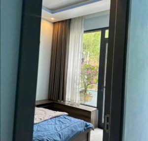 a reflection of a bedroom with a bed and a window at Love Hotel in Hanoi
